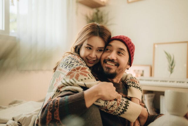 happy couple embracing at home