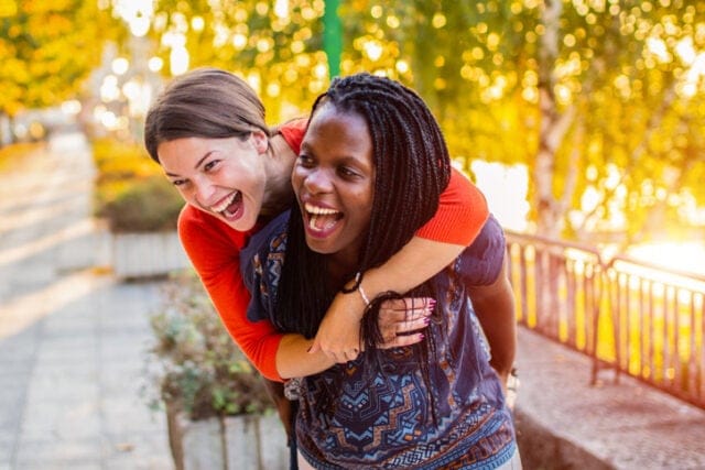 best friends smiling outdoors