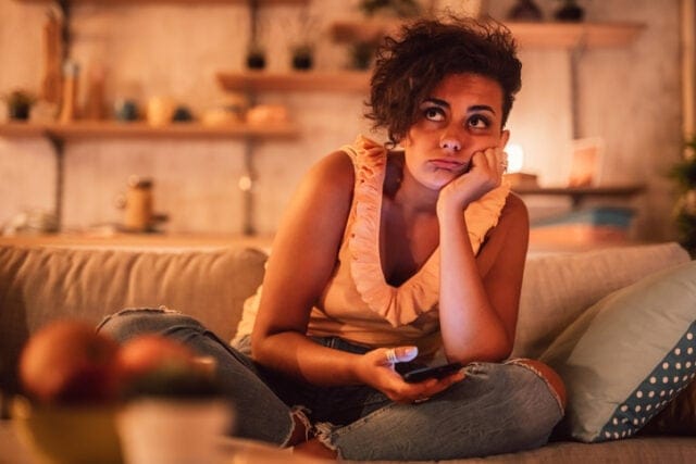 bored woman watching tv