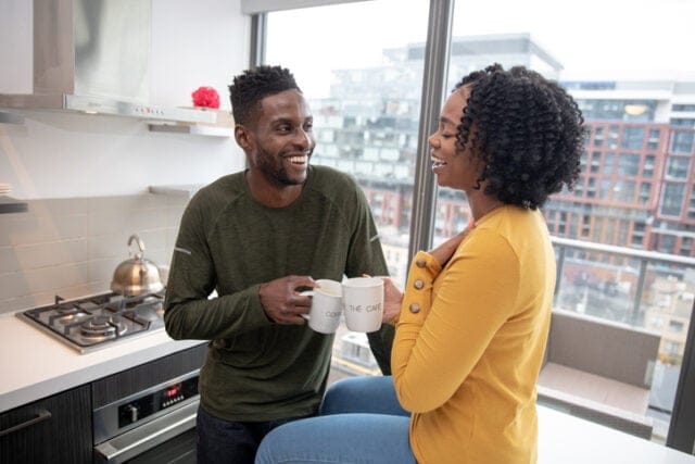 couple chatting over coffee in kitchen