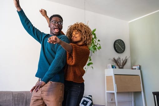 Couple doing a happy dance.