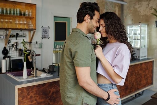 couple sharing romantic embrace living room