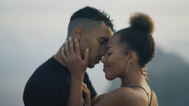 couple sharing a romantic kiss on hazy day