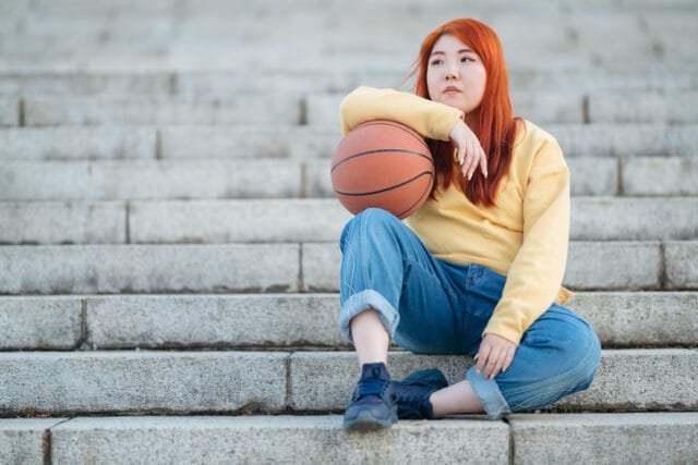 woman on stairs with basketball
