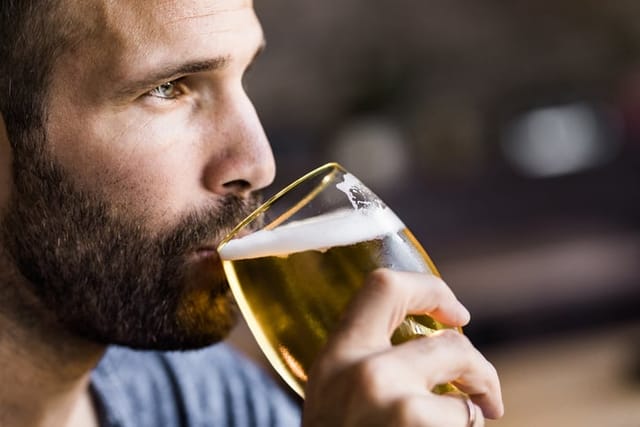 close-up of man drinking beer