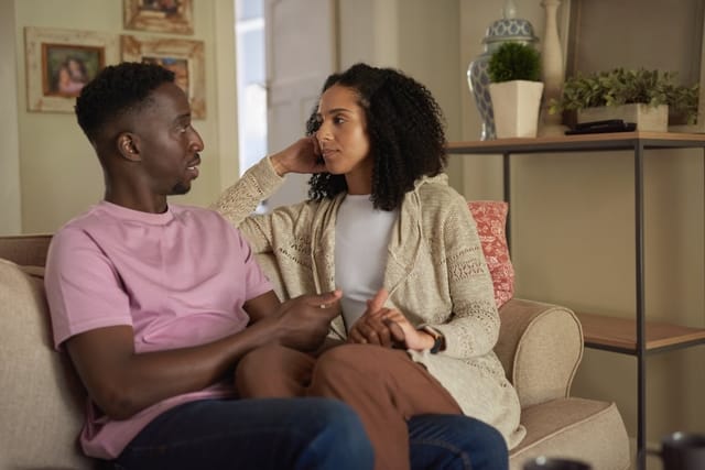 Young couple talking at home.