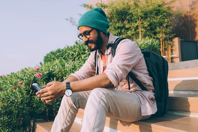 hipster man texting outdoors