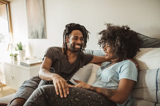 happy couple chatting on couch