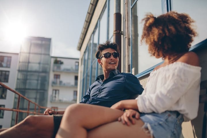 young couple on bench in sun