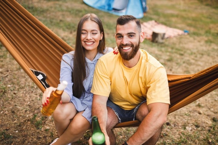 couple sitting together on a hammock