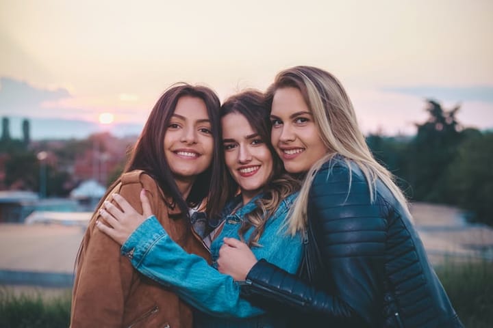 three women hugging each other