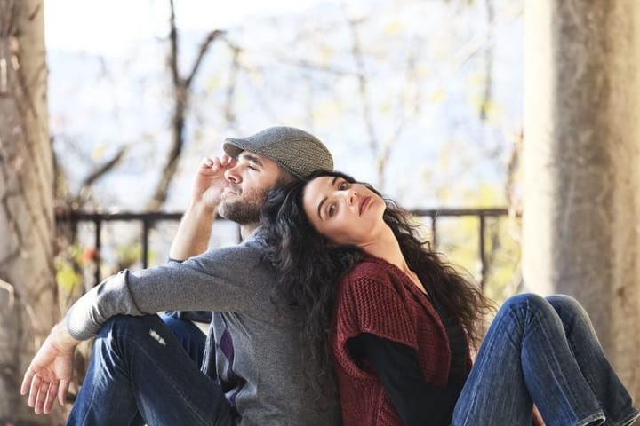 couple sitting back to back