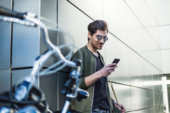 Hipster man with bike and phone