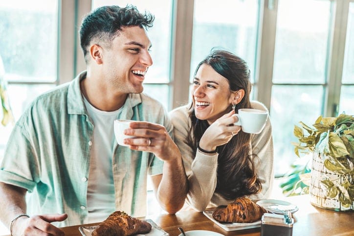 happy couple enjoying coffee breakfast