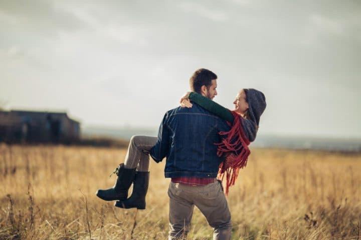 happy couple close field
