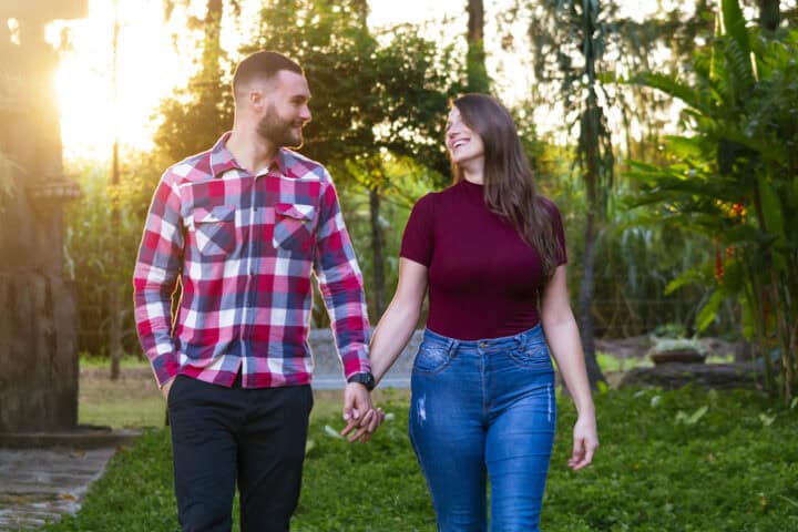 couple holding hands in park